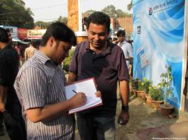 Ananta Bijoy Das giving autograph to Avijit Roy
